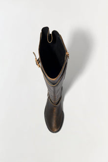 Black leather over-the-knee boot with gold-tone hardware and buckle details, shown from above against a white background.