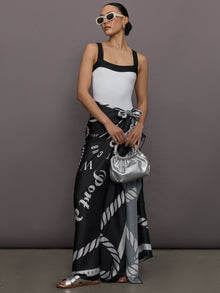 Model wears a high cut one piece square neck bathing suit in white with black edges. 