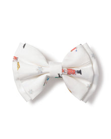 The Girls Twill Hair Bows in A Night at the Nutcracker by Petite Plume feature nutcracker images and subtle snowflakes, adding a playful touch reminiscent of a Sugar Plum Fairys whimsical charm.