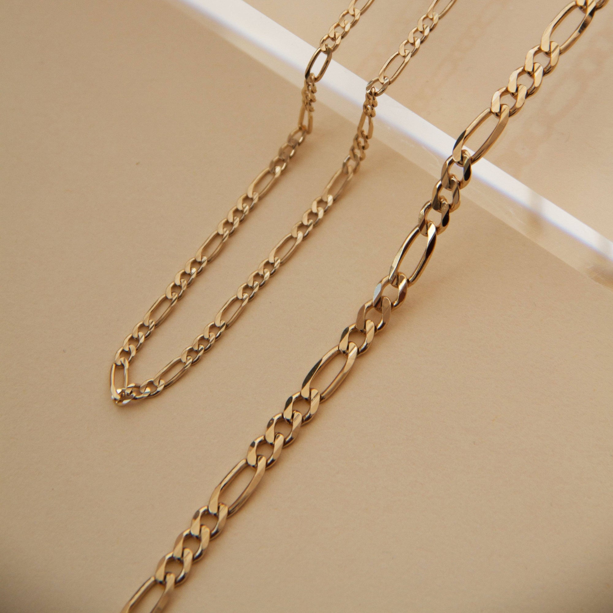 Flatlay Model. Close up of two chain necklaces on neutral background