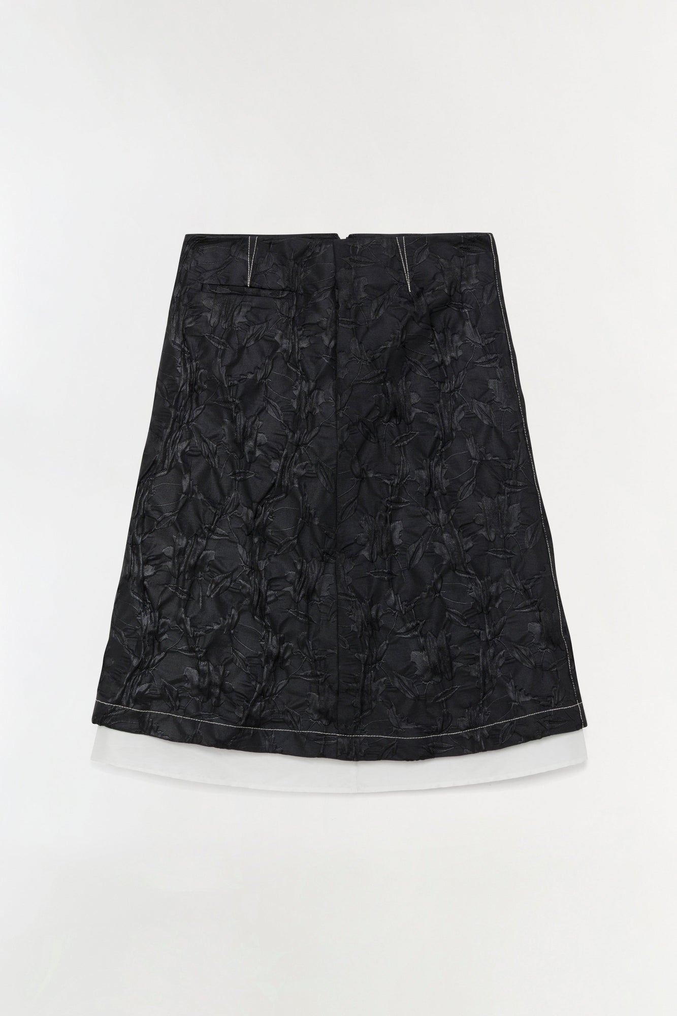 Black jacquard midi skirt with floral pattern and white underskirt, A-line silhouette.