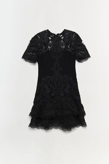Black short-sleeved dress with intricate lace paisley pattern and tiered lace hem detail.