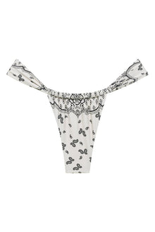 Cream-colored bikini bottom with black bandana paisley print and decorative waistband ties.