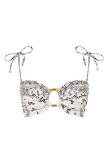 Cream bandeau bikini top with black bandana print, gold ring hardware, and tie-shoulder straps.