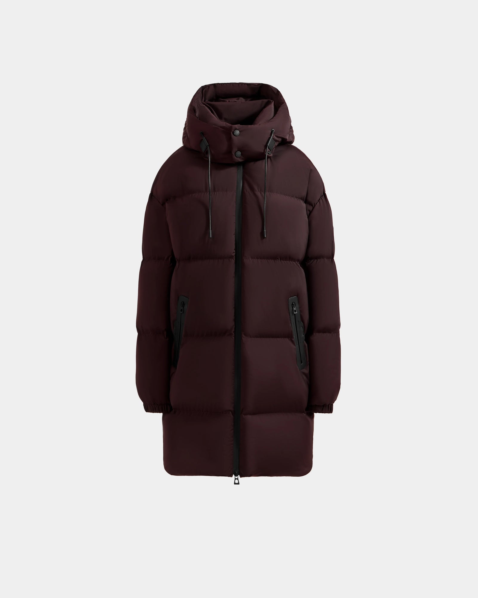The Rudsak KARLEE L - 8125682 Bordeaux is a women's long down puffer winter jacket in dark brown with a hood, zip front, snap buttons, black zip pockets, and drawstrings—ideal for cold weather and shown on a plain light gray background.