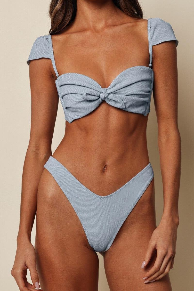 Light blue denim bikini bottom with textured fabric and high-cut leg openings.