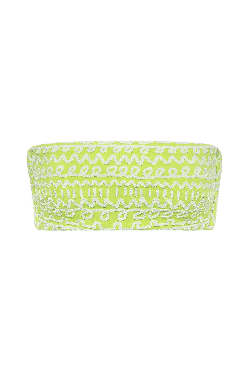 Lime green bikini top with white geometric and abstract patterns throughout.