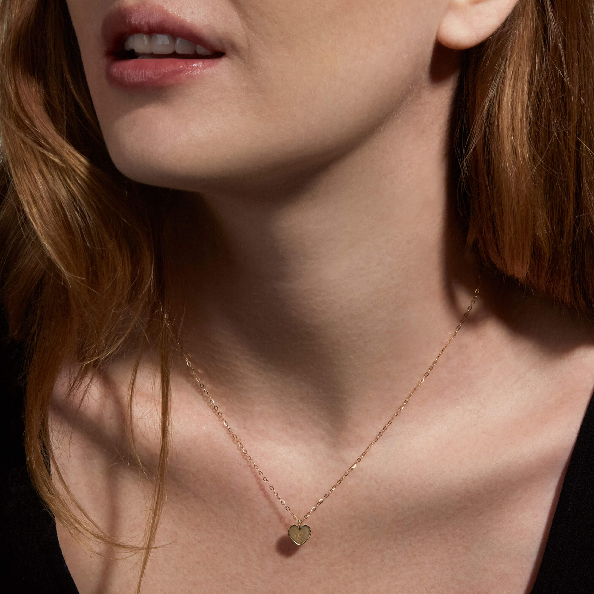 Image of 10K Yellow Gold Mini Heart Medallion Necklace on Models Neck
