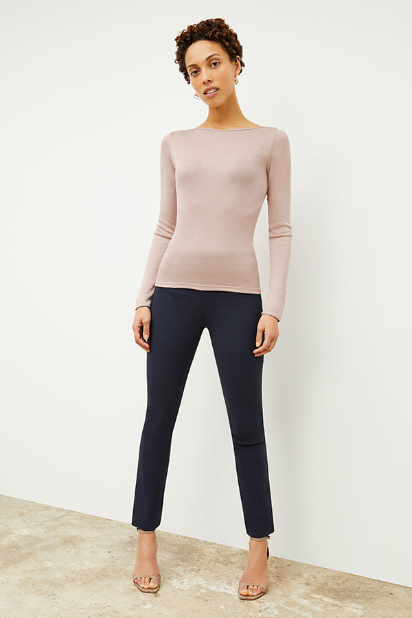 Side image of a woman standing wearing the curie pant in dark navy | Exclude