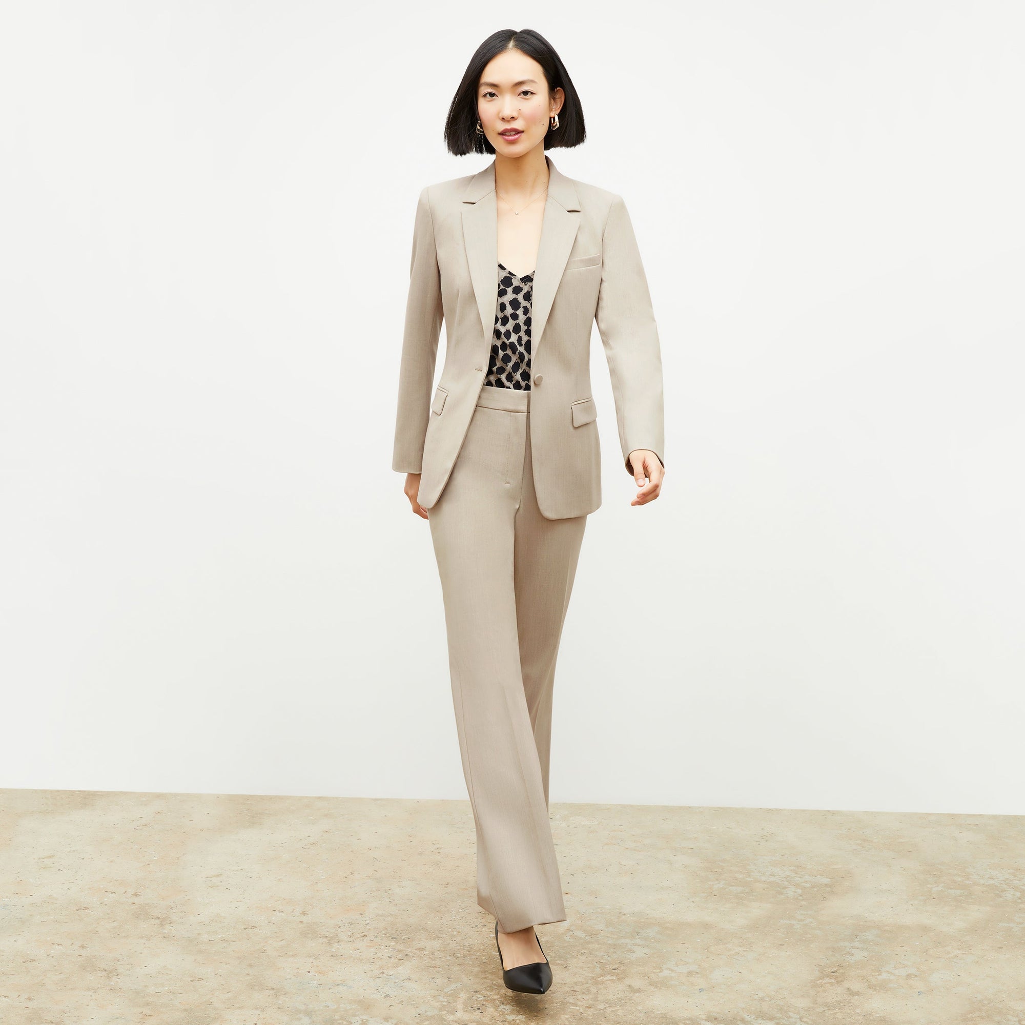 Front image of a woman standing wearing the Lisey Cami—Sahara Print Washable Silk in Tan/Black | Exclude