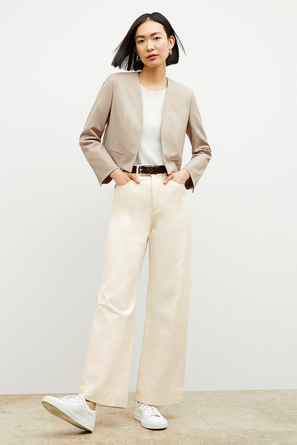 Front image of a woman standing wearing the milo jean in tusk | Exclude