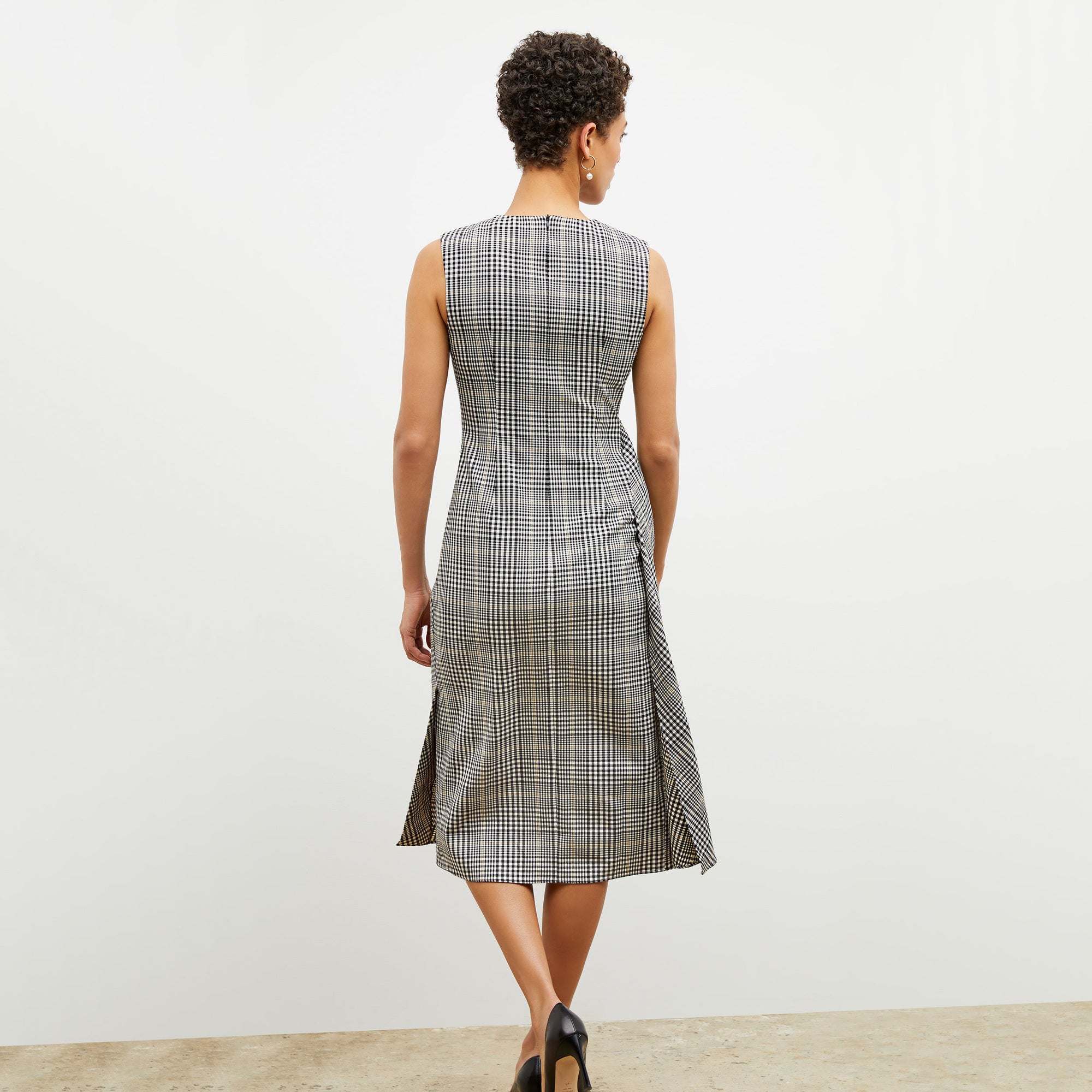 Back image of a woman wearing the jeannine dress in plaid sharkskin