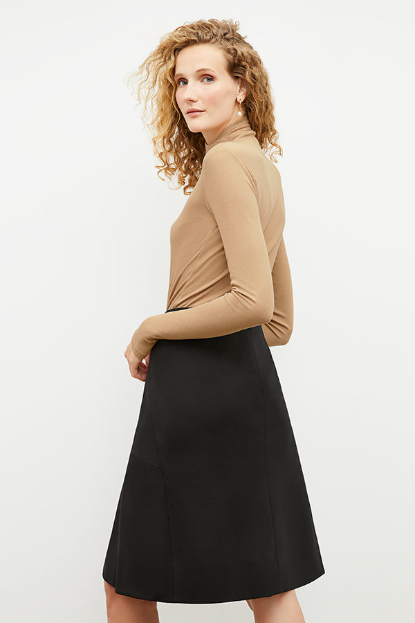 Front image of a woman standing wearing the axam top in camel | Exclude