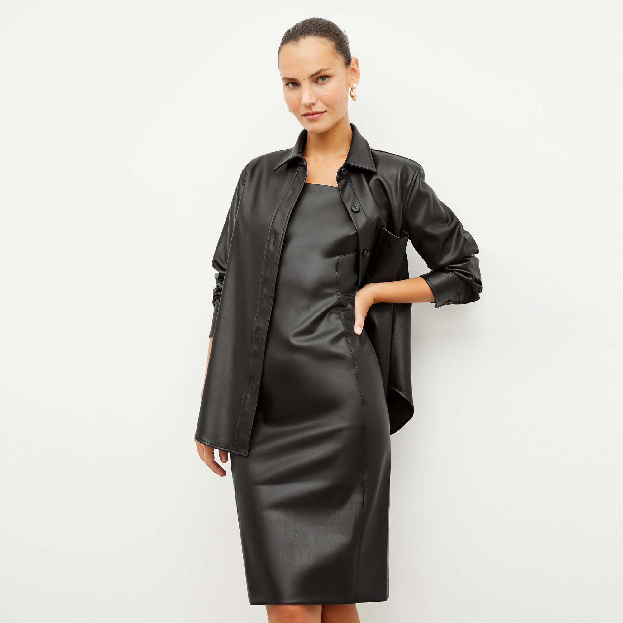Front image of a woman wearing the noa dress in black