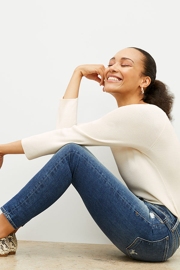 side image of a woman wearing the Joya Top in Cream | Exclude
