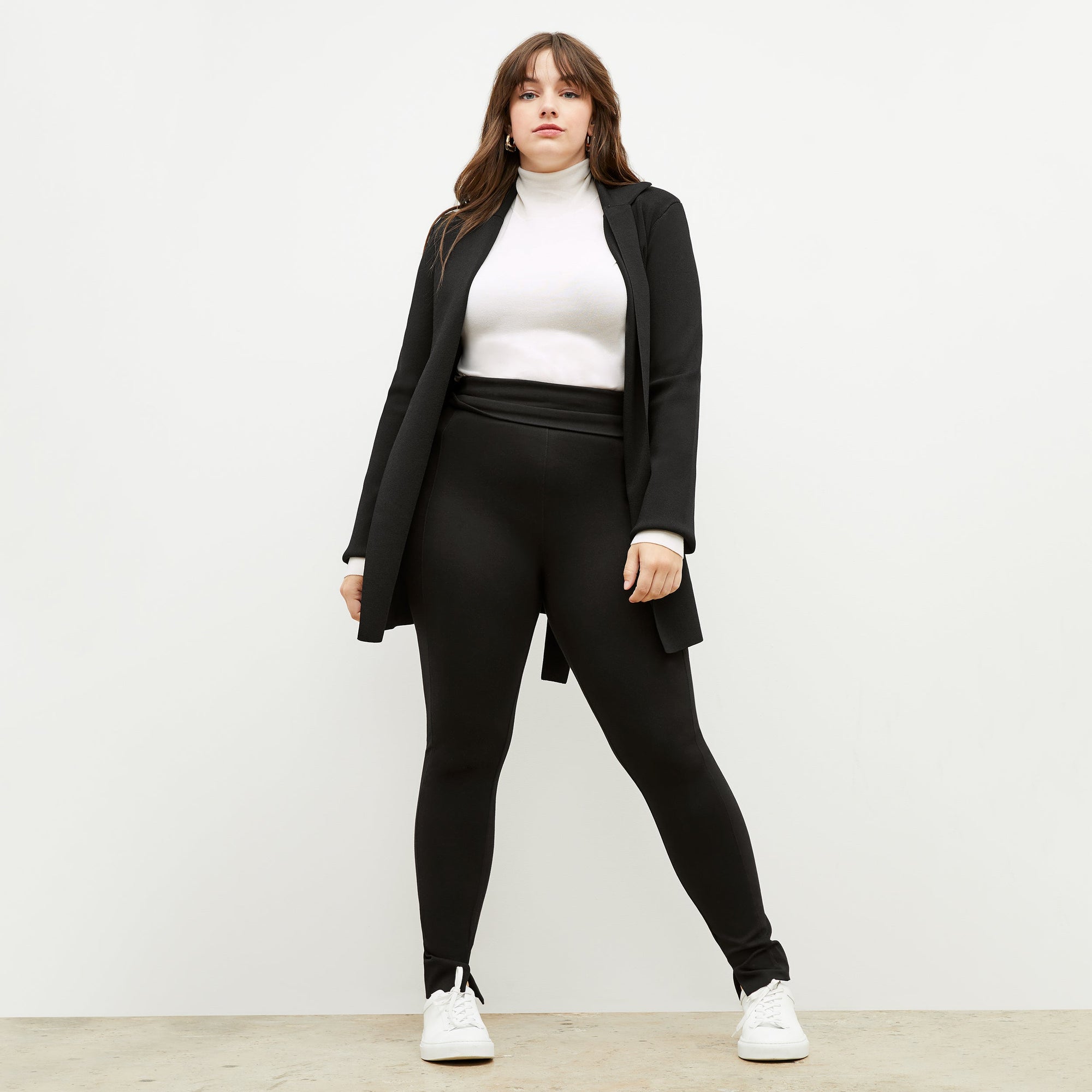 Front image of a woman standing wearing the axam top in ivory | Exclude