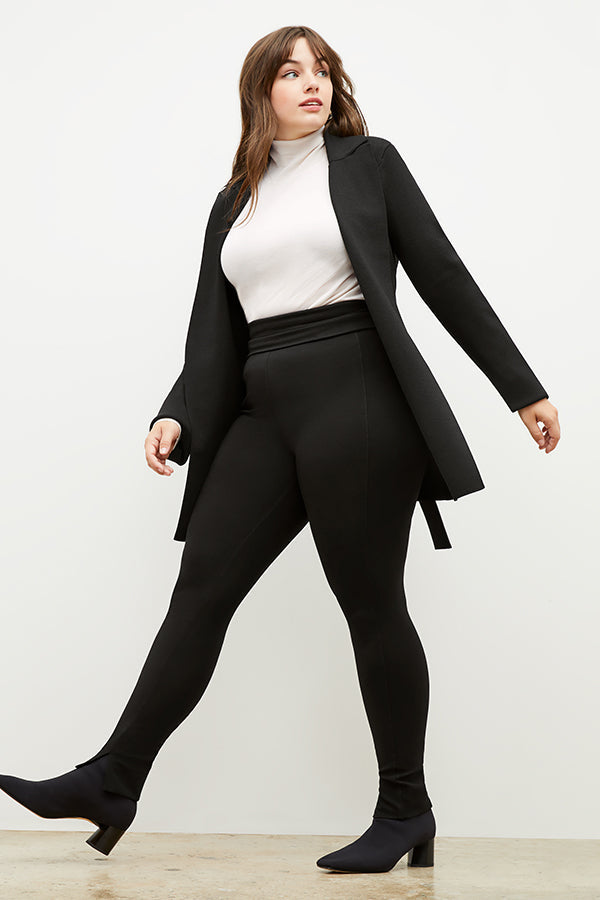 Front image of a woman standing wearing the axam top in ivory | Exclude