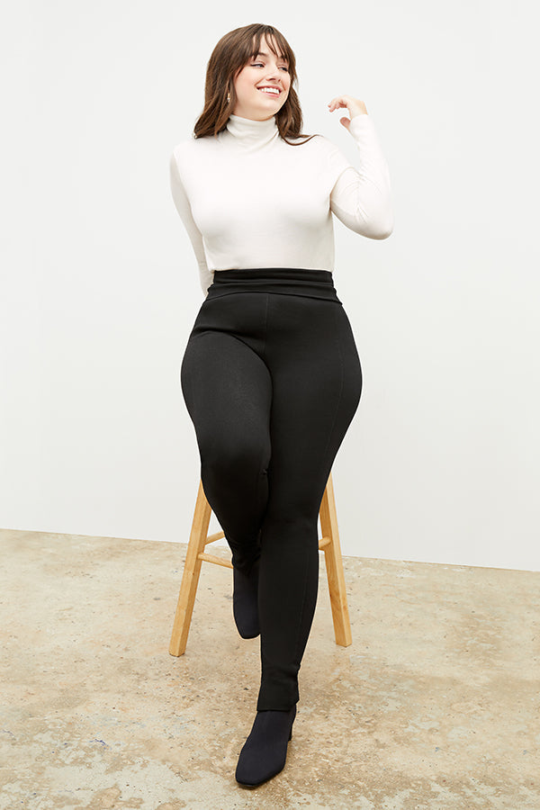 Front image of a woman standing wearing the axam top in ivory Front image of a woman standing wearing the axam top in ivory | Exclude