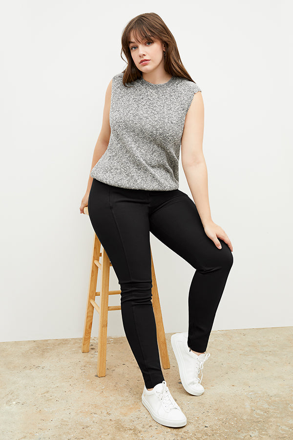 Side image of a woman standing wearing the curie pant in black | Grid Hover | Exclude
