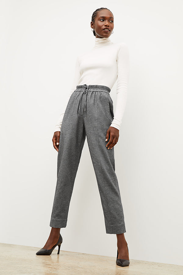 Front image of a woman standing wearing the axam top in ivory | Exclude