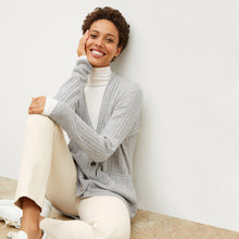 Front image of a woman standing wearing the axam top in ivory