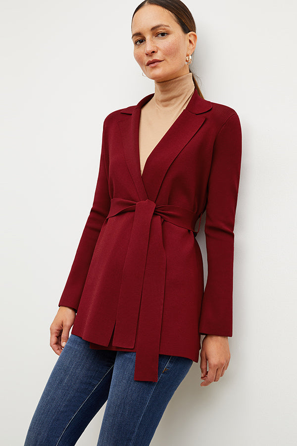 Front image of a woman standing wearing the axam top in camel | Exclude