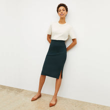 Front image of a woman standing wearing the leslie top in compact cotton in ivory