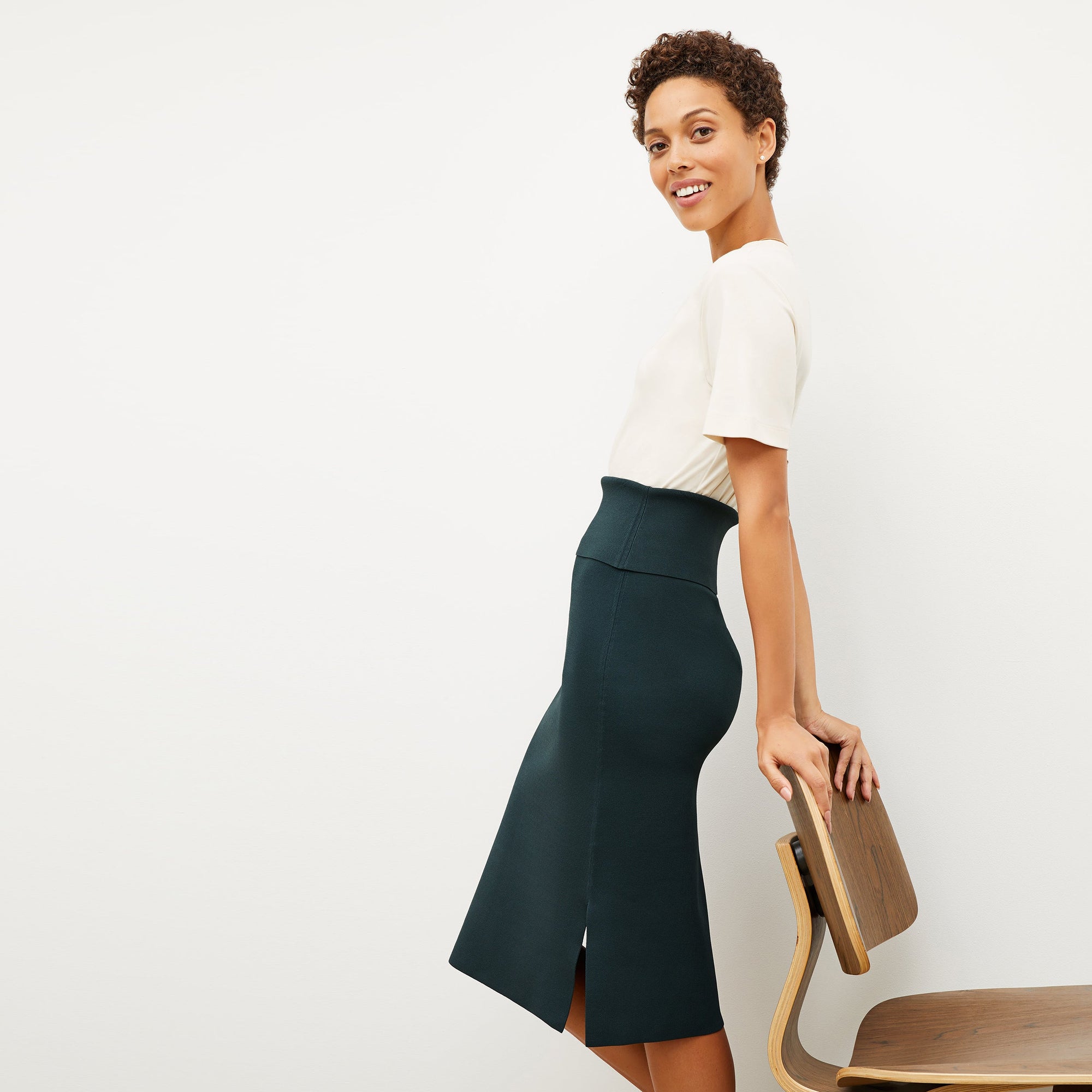 Front image of a woman standing wearing the leslie top in compact cotton in ivory | Exclude