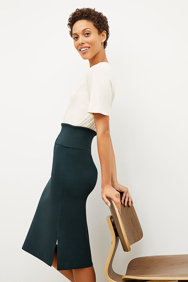 Front image of a woman standing wearing the leslie top in compact cotton in ivory | Exclude
