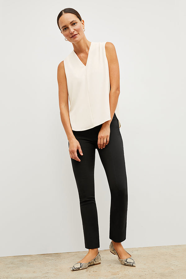 Front image of a woman standing wearing the Foster Pant—Everstretch in Black | Exclude