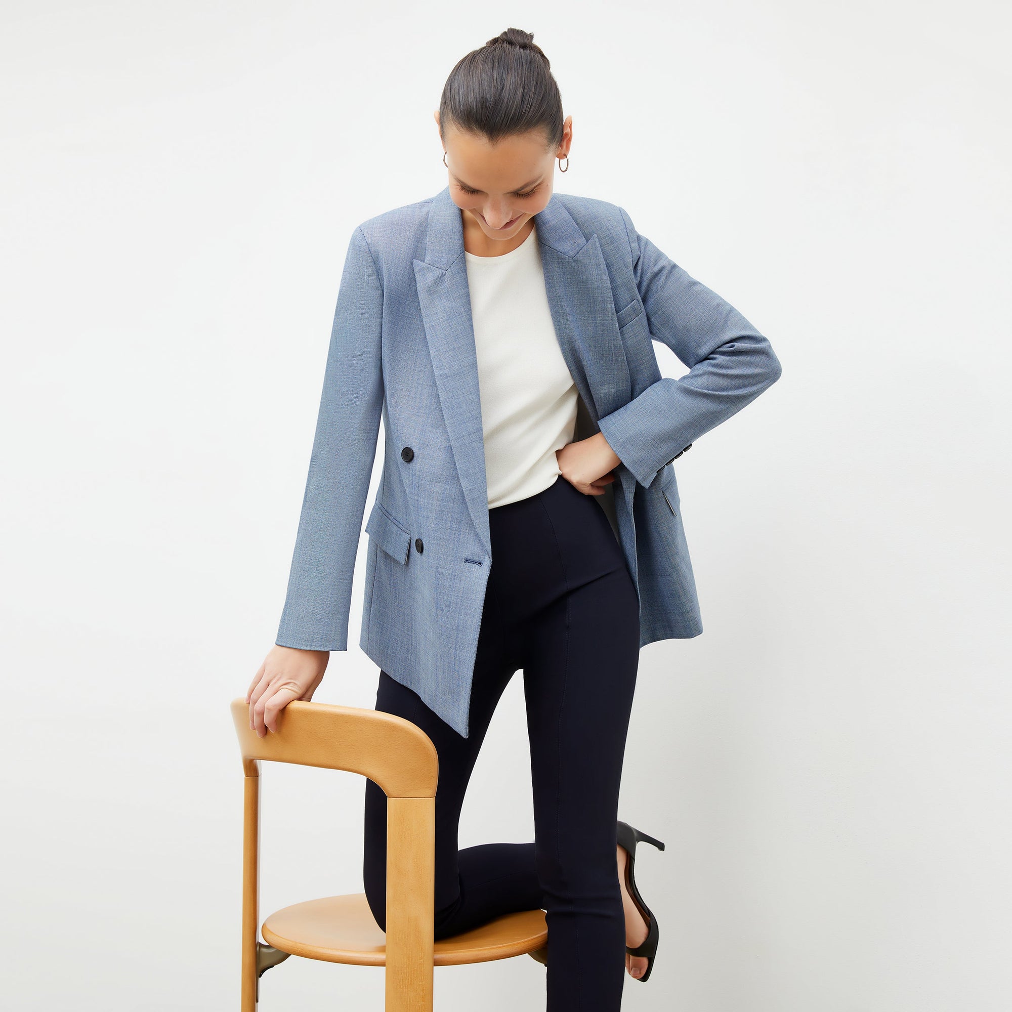 Front image of a woman standing wearing the foster pant in dark navy | Exclude