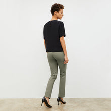 Back image of a woman wearing the foster pant in thyme