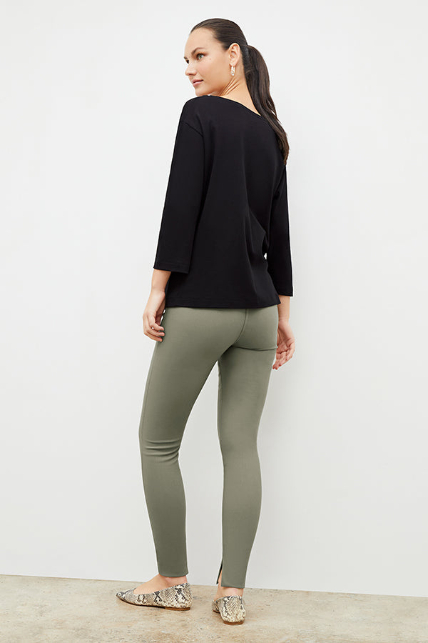 Back image of a woman wearing the skinny foster in thyme | Exclude