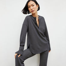 Front image of a woman wearing the horton pant in black and white houndstooth