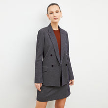 Front image of a woman wearing the whitney skirt in black and white