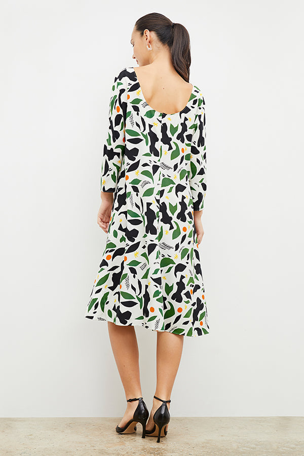 Back image of a woman wearing the alesia dress in icon print | Exclude