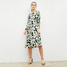 Front image of woman wearing the alesia dress in icon print