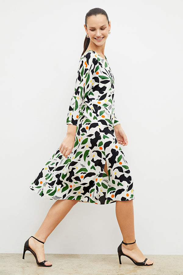 Side image of a woman wearing the alesia dress in icon print | Exclude