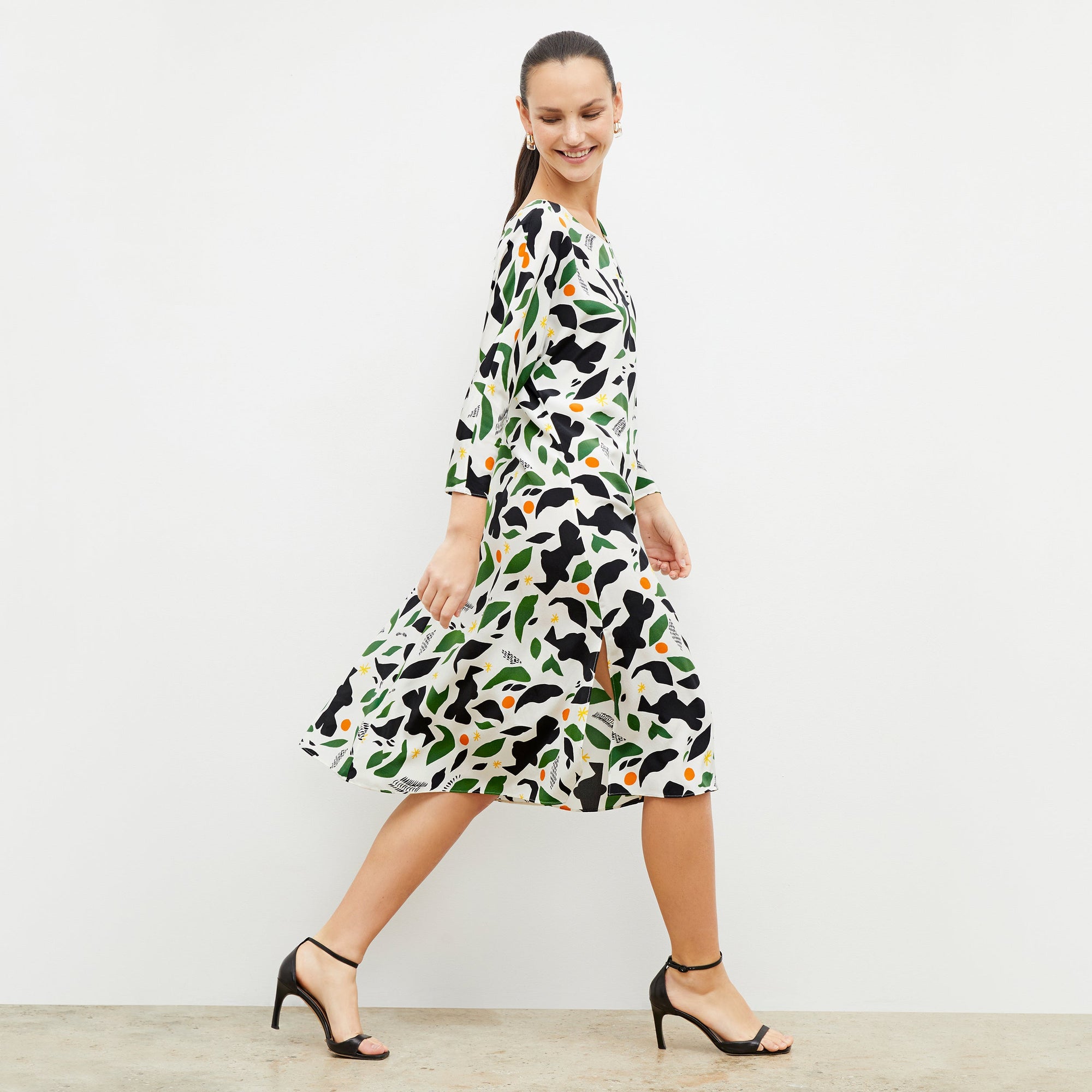 Side image of a woman wearing the alesia dress in icon print