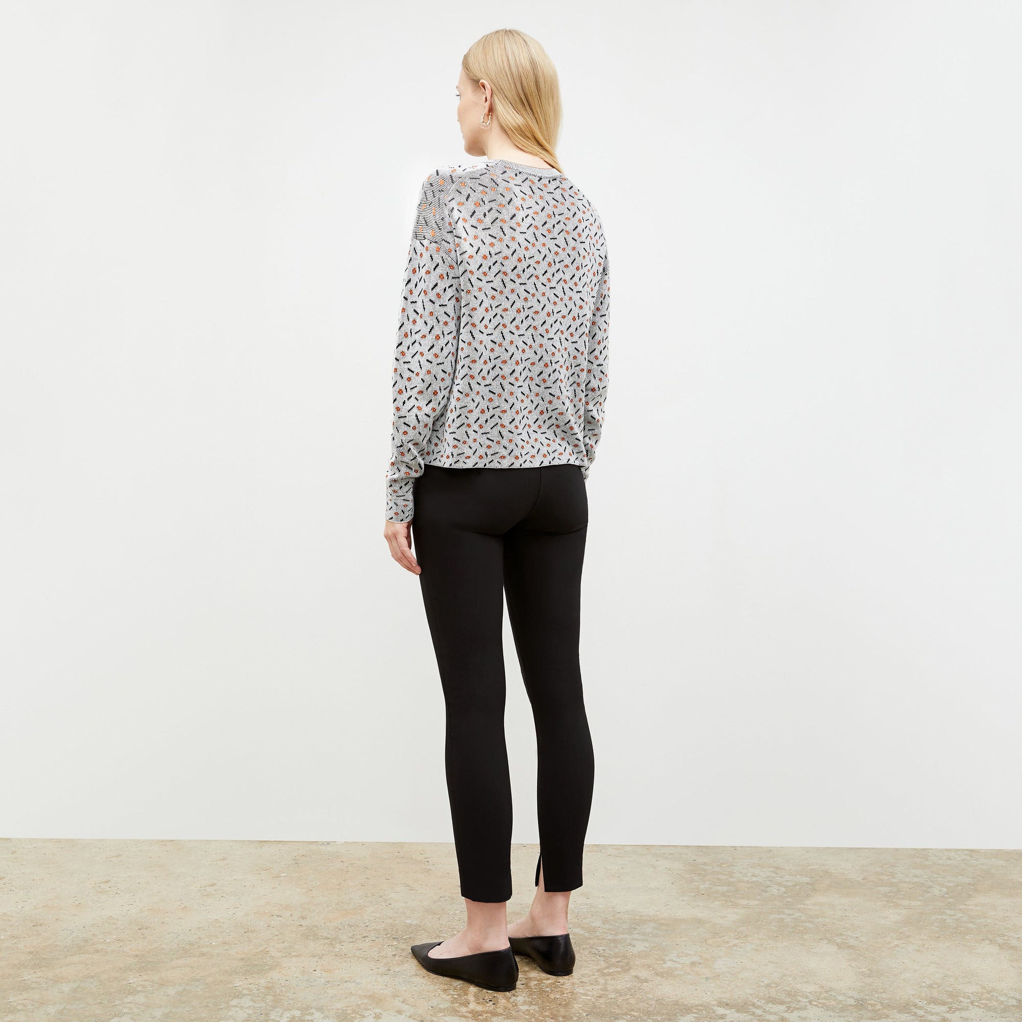 Back image of a woman wearing the Tyler Sweatshirt in Brick and Black