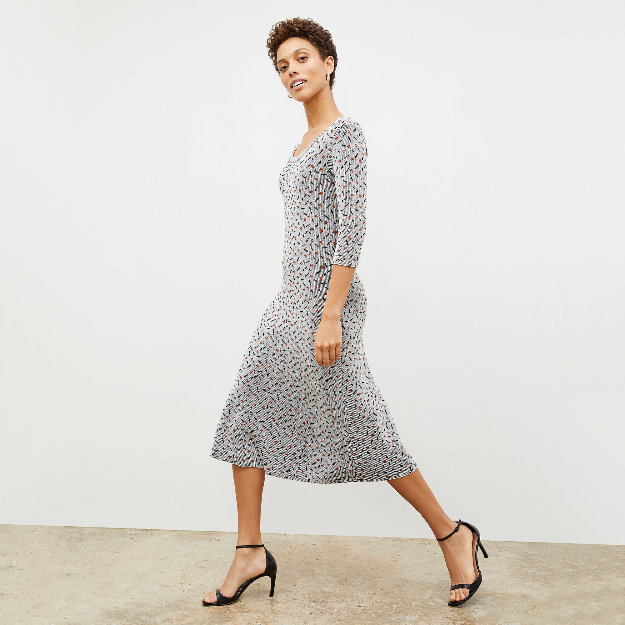 Side image of a woman wearing the Tippy Dress in Brick and Black
