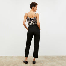 Back image of a woman standing wearing the Lisey Cami—Sahara Print Washable Silk in Tan/Black