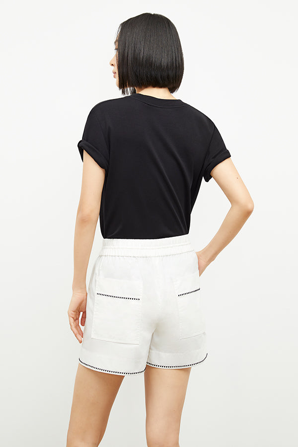 front image of a woman wearing the adina short in white | Exclude