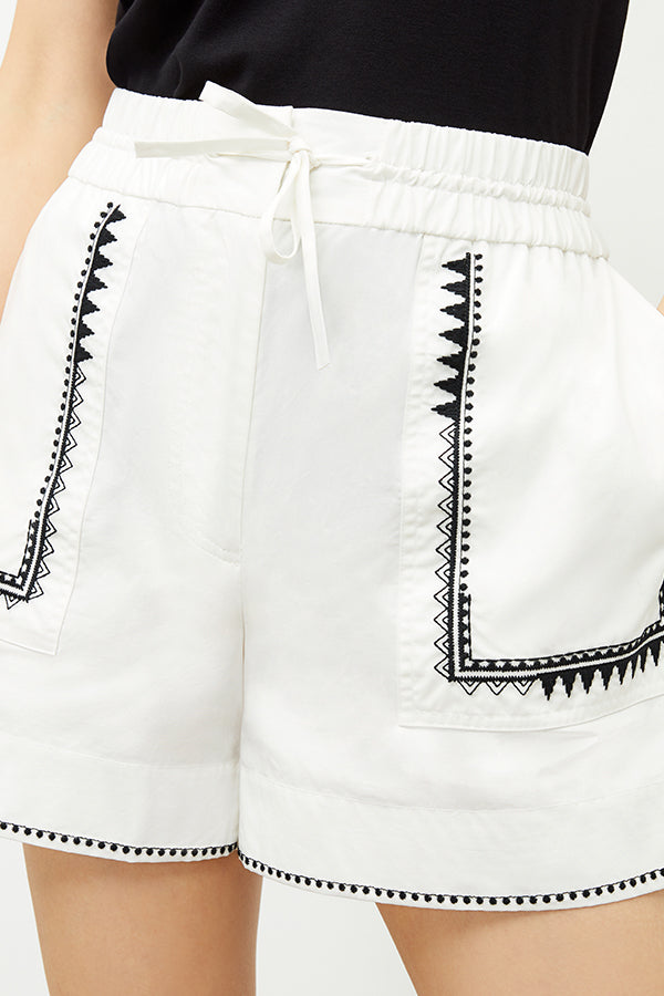 front image of a woman wearing the adina short in white | Exclude | Grid Hover