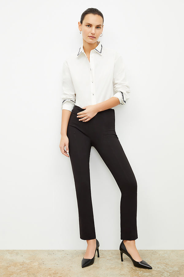 Front image of a woman standing wearing the Foster Pant—Everstretch in Black | Exclude