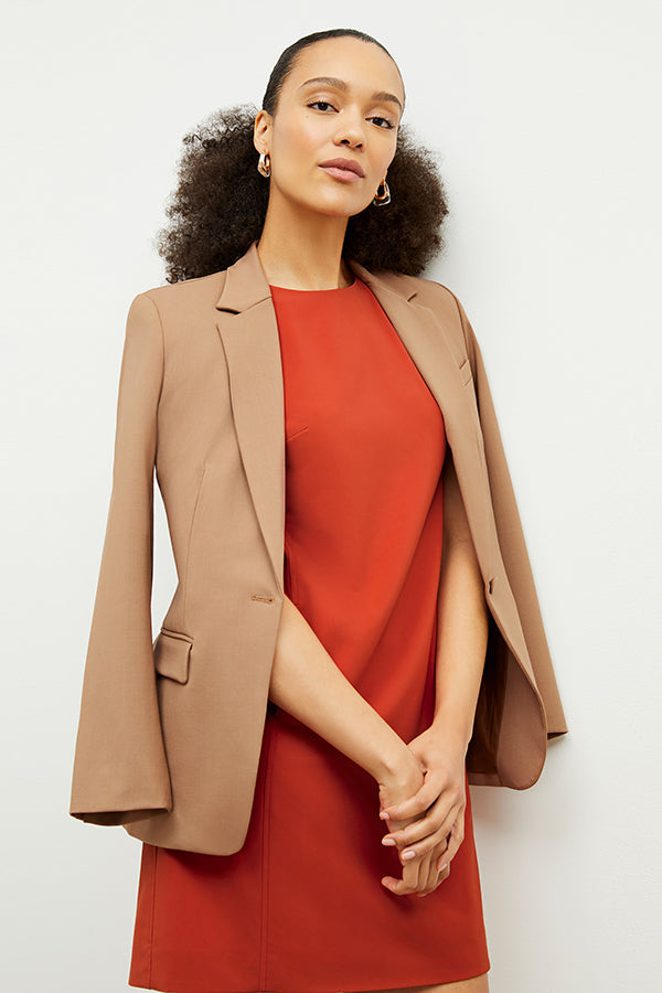 Front image of a woman standing wearing the Yiyan Blazer in Camel | Exclude