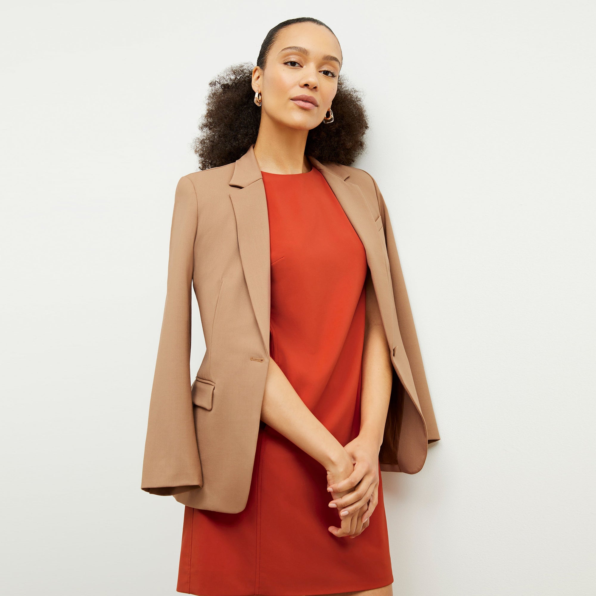 Front image of a woman standing wearing the Yiyan Blazer in Camel | Exclude