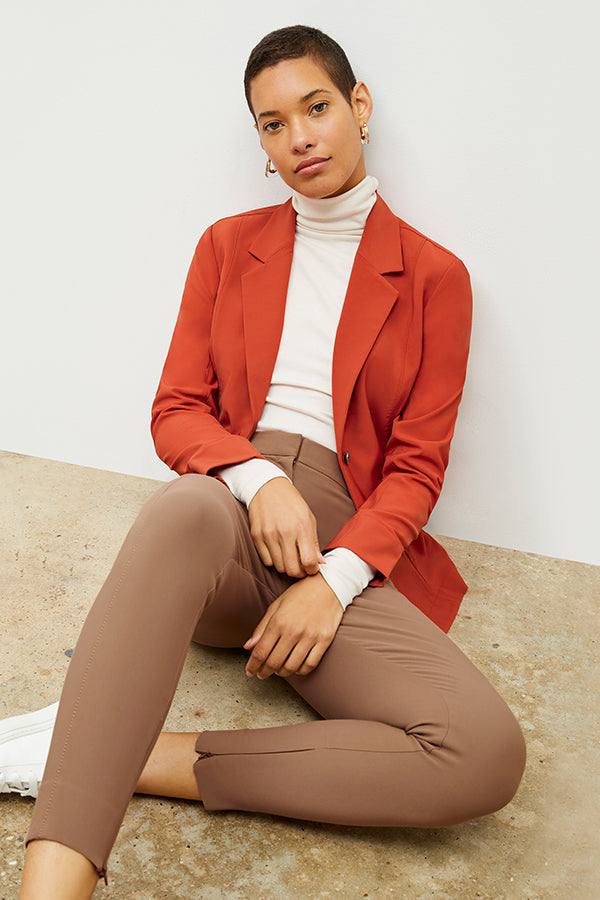 Front image of a woman standing wearing the axam top in ivory | Exclude