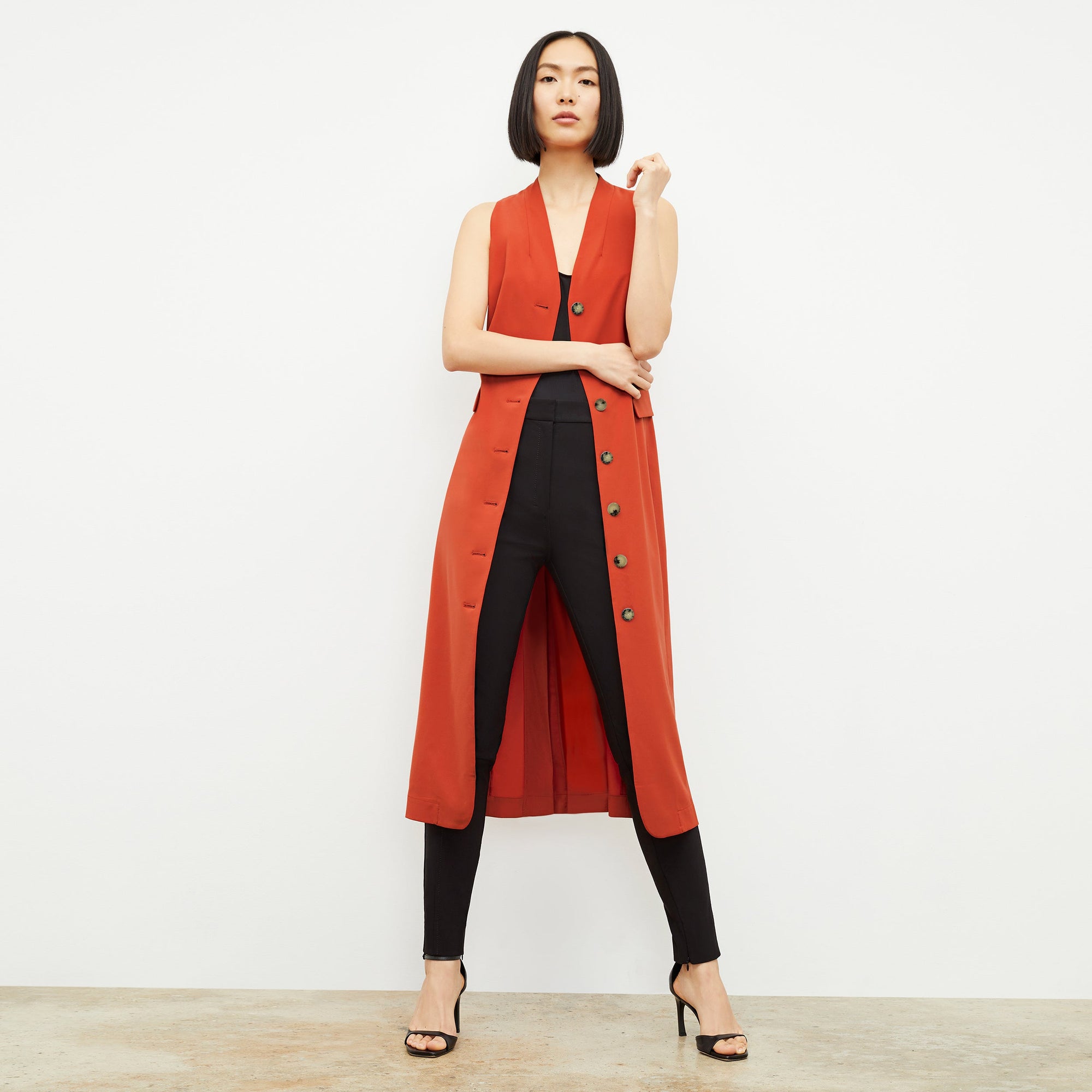 Front image of a woman standing wearing the curie pant in black | Exclude