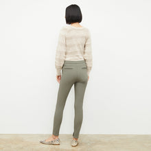 Back image of a woman wearing the skinny foster in thyme